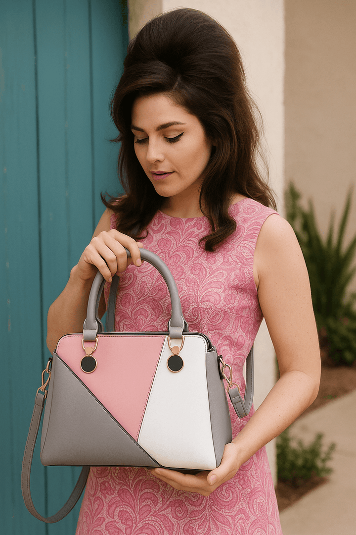 Model showcasing the LuLu 60s Mod Handbag with pink, gray, and white geometric design, perfect for retro fashion.