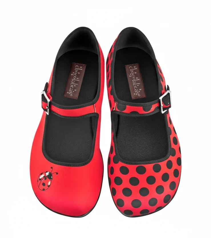 Red polka dot shoes with a ladybug design on a white background