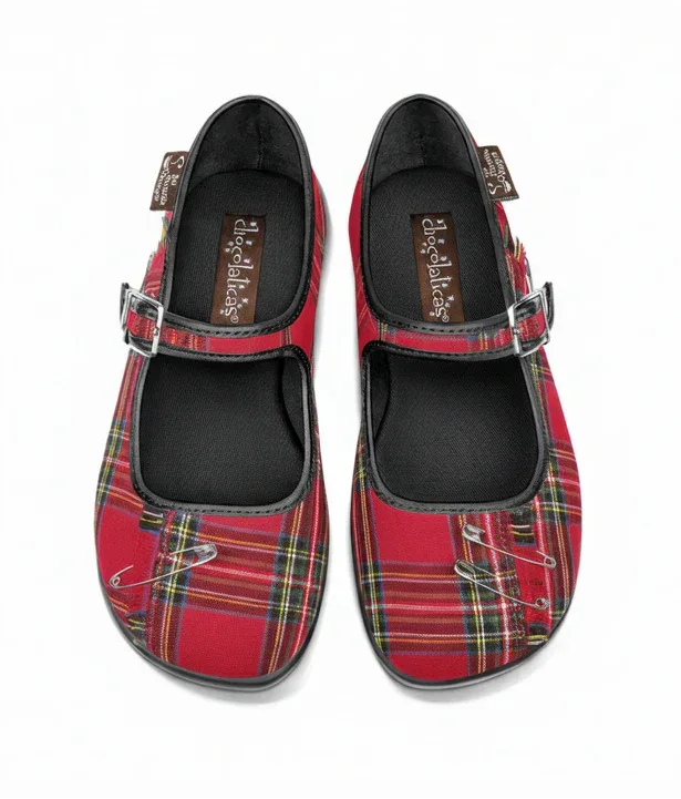 Red plaid shoes with safety pin details on a white background