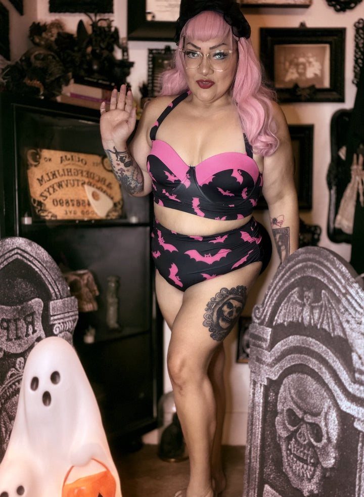 Mindy Morbs wearing the black and pink bat retro bikini