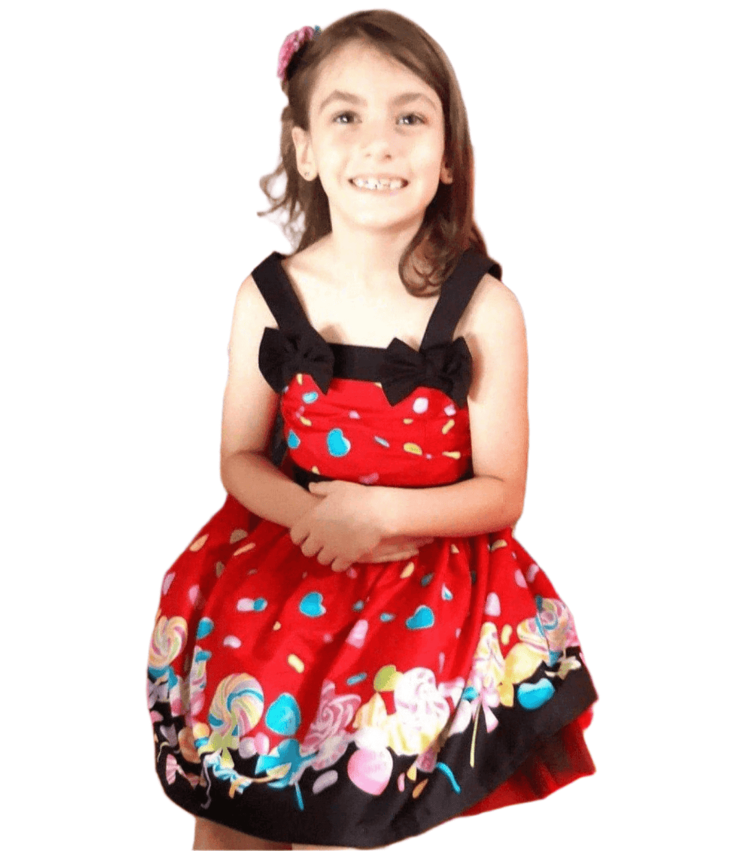 Girl smiling in a bright red Rockabilly dress with candy print, perfect for parties and special occasions.