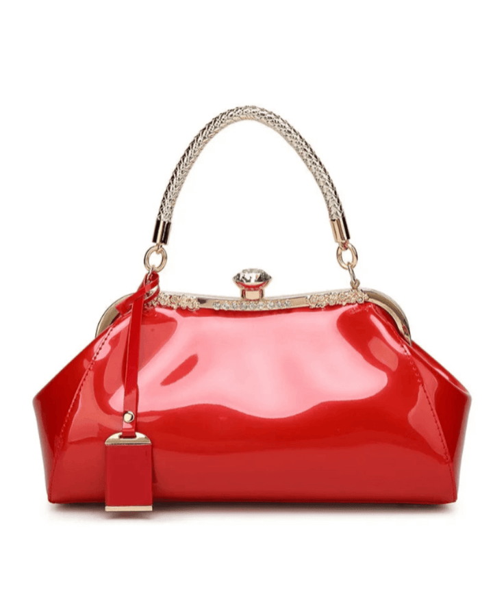 Red patent women's handbag with rhinestone clasp and elegant handle for a chic accessory collection.