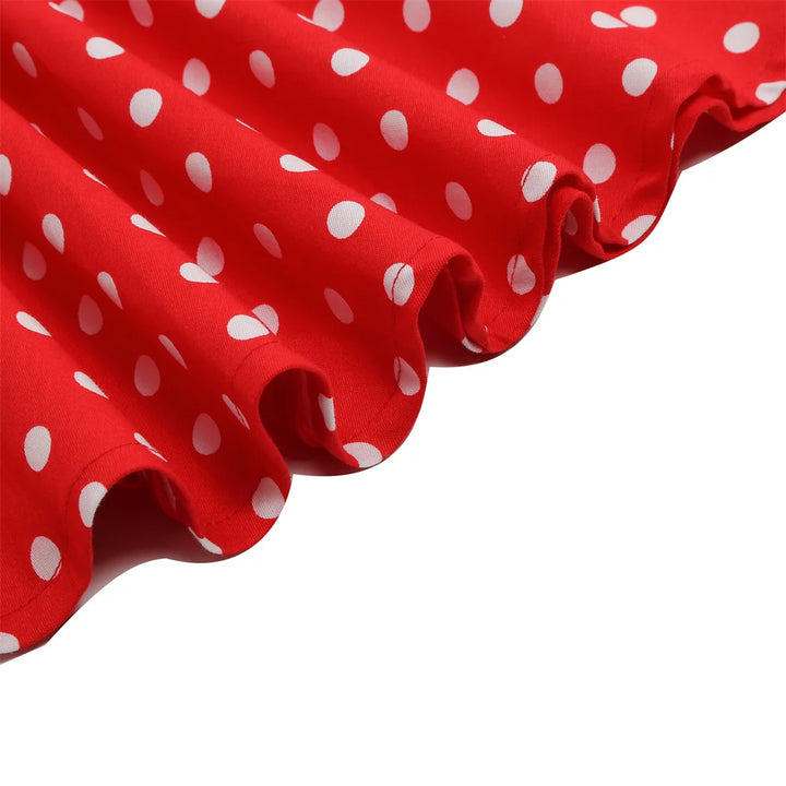 Close-up of the red polka dot fabric showcasing playful white dots for a halter rockabilly dress.
