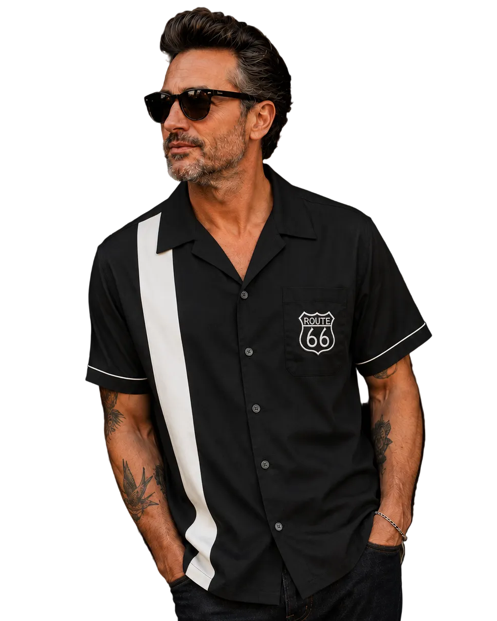 A man wearing a black short-sleeve button-up shirt with a bold white vertical stripe down the front and a white Route 66 shield patch on the chest, paired with black pants and sunglasses against a plain white background.