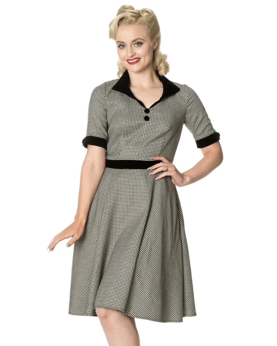 Woman wearing a vintage-style dress with a checkered pattern on a white background