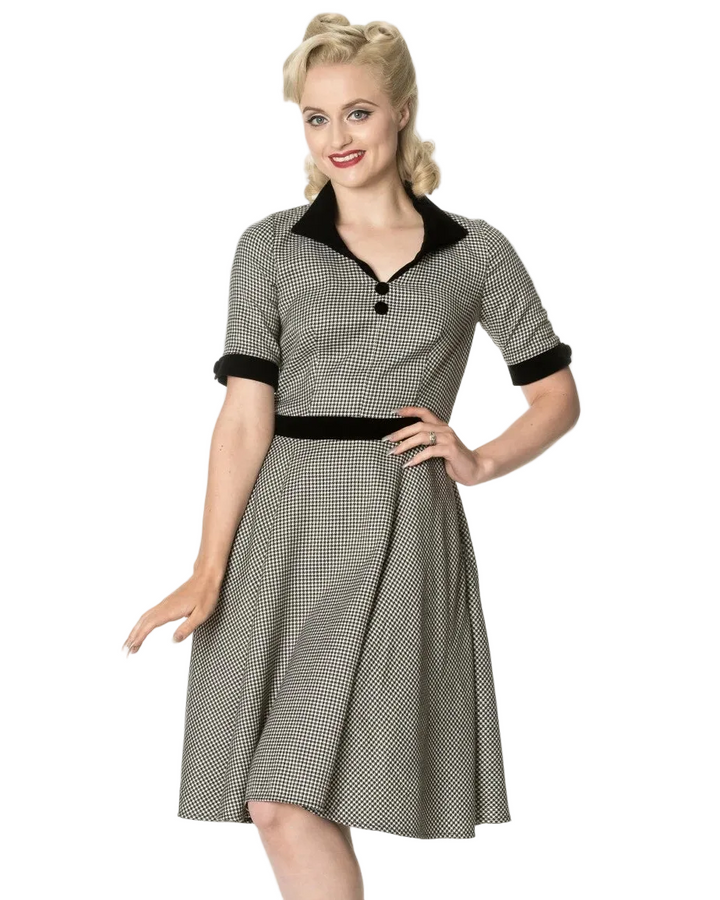 Woman wearing a vintage-style dress with a checkered pattern on a white background