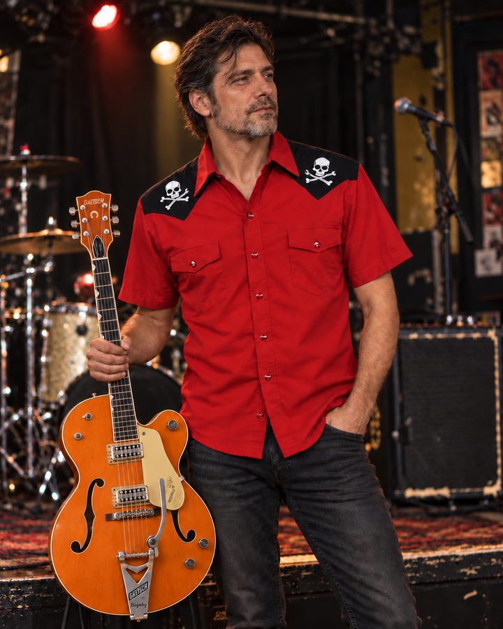 Man wearing the red and black Steady Clothing Skull and Bones western shirt at a music venue