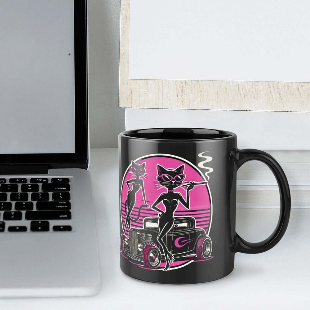 Sleek black mug featuring seductive cats and classic car design, perfect for bold coffee lovers.
