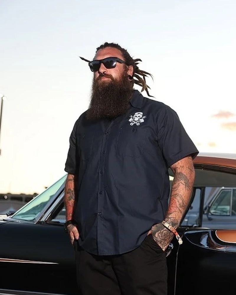 Man wearing the navy Built for Speed workshirt beside a classic car, showing the front and chest print