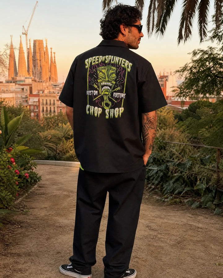 Man wearing the black and lime Speed N Splinters bowling shirt outdoors, showing the back print
