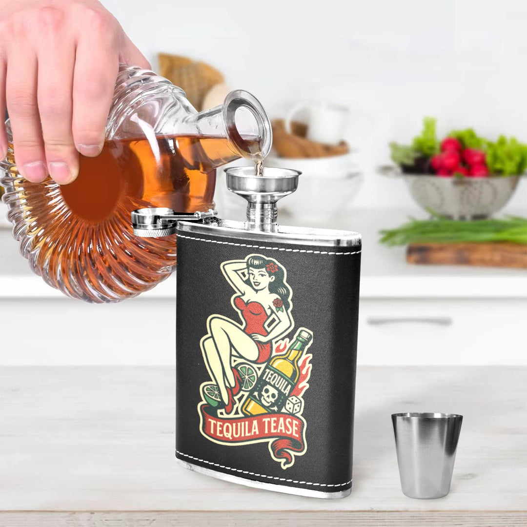 Person pouring liquor into Tequila Tease 8 oz black hip flask on a kitchen counter.