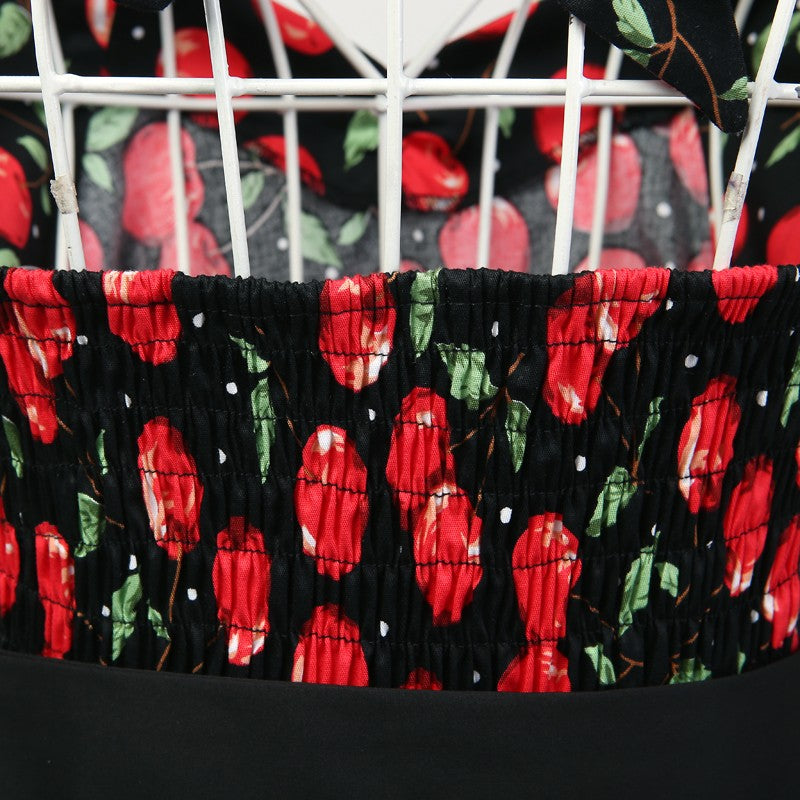 Black fabric with red floral pattern draped over a white structure