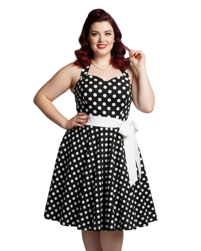 Woman wearing a black and white polka dot dress with a white belt on a white background