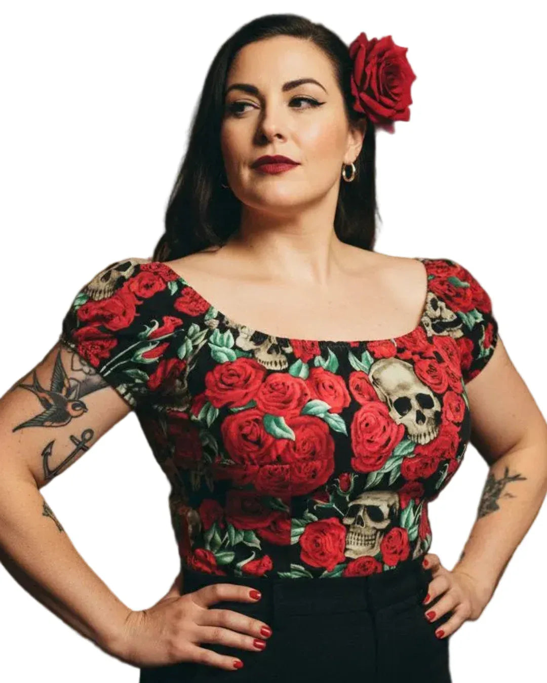 Woman wearing a top with red floral and skull design on a white background