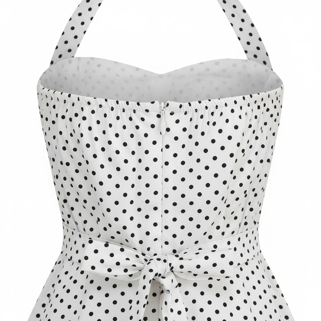 White strapless top with black polka dot pattern on a white background