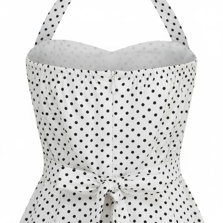 White strapless top with black polka dot pattern on a white background