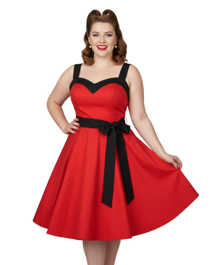 Woman wearing a red dress with black accents on a white background