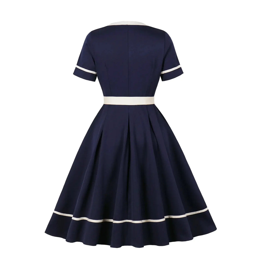 Vintage 1950s Navy Swing Dress back view highlighting the fit-and-flare silhouette and white trim details.
