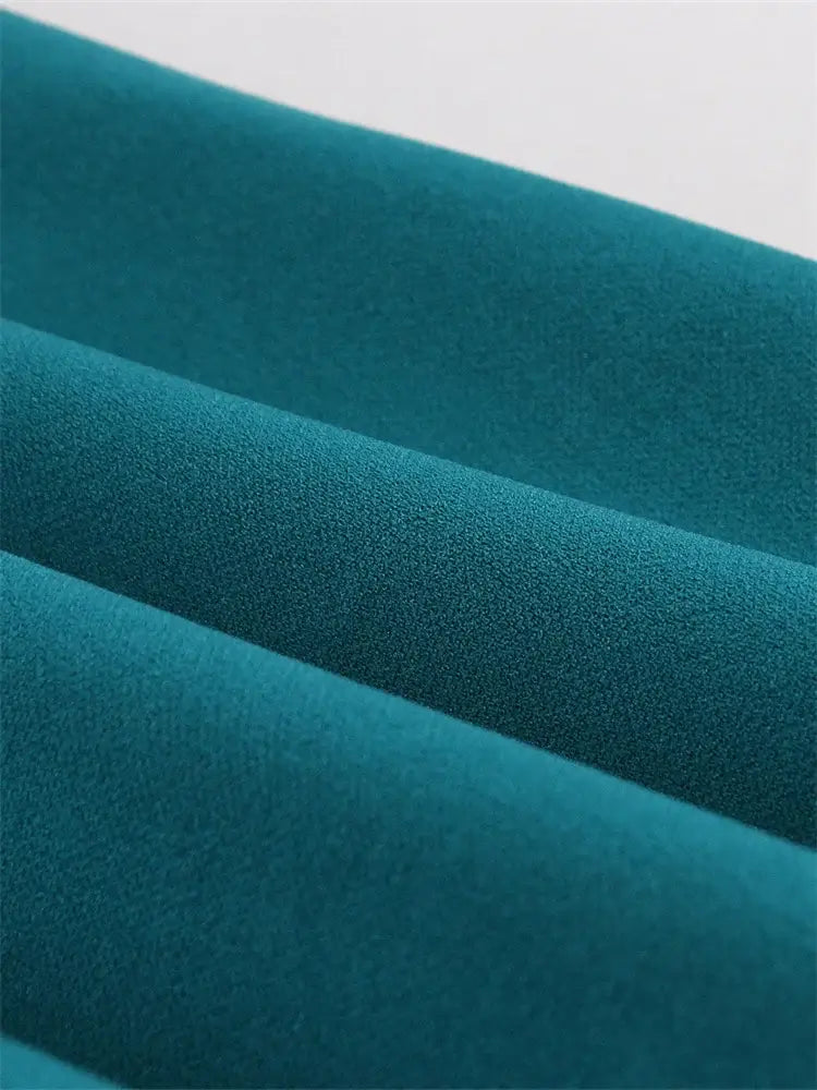 Close-up of soft teal fabric for Vintage Teal Swing Dress With Pockets, showcasing the texture and color.
