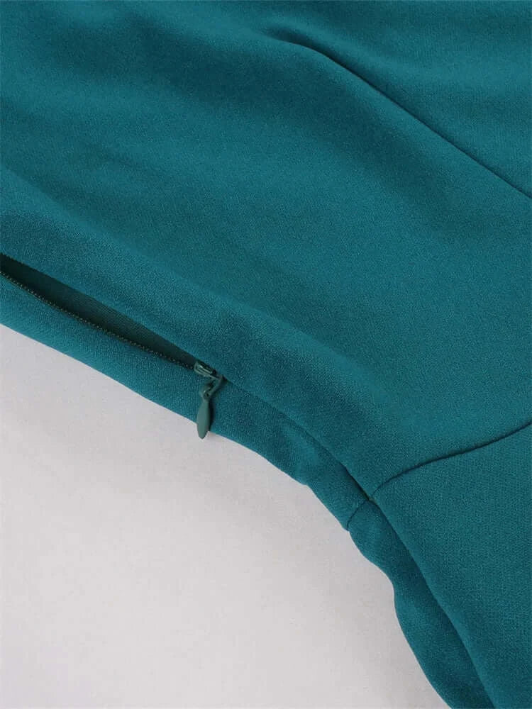 Vintage Teal Swing Dress With Pockets detailed view showing the fabric and zipper.